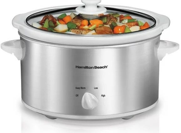 a silver slow cooker containing cooked vegetables