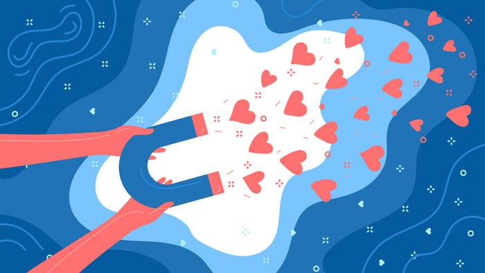 Illustration showing two hands holding a magnet with many hearts coming toward it