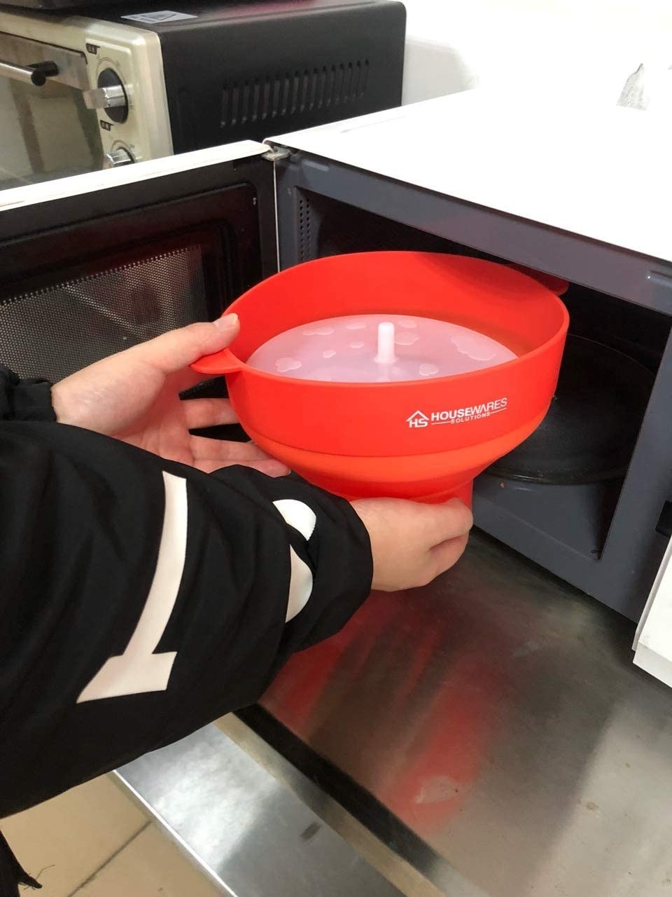 person putting the container in their microwave