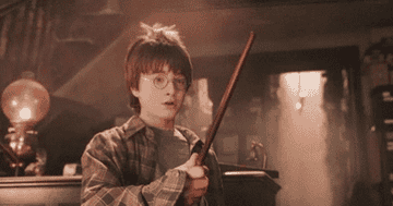 Harry Potter holds a wand