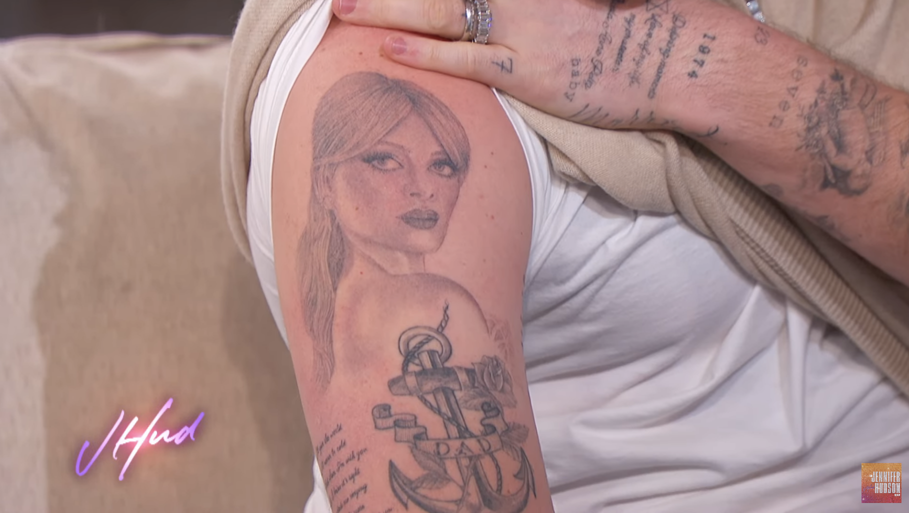 A simple portrait of Nicola looking slightly over her shoulder. The tattoo is above a tattoo of an anchor with &quot;Dad&quot; written across it