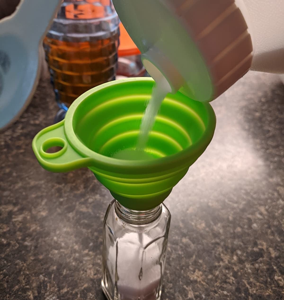 Reviewer image of green funnel being used to refill a salt shaker