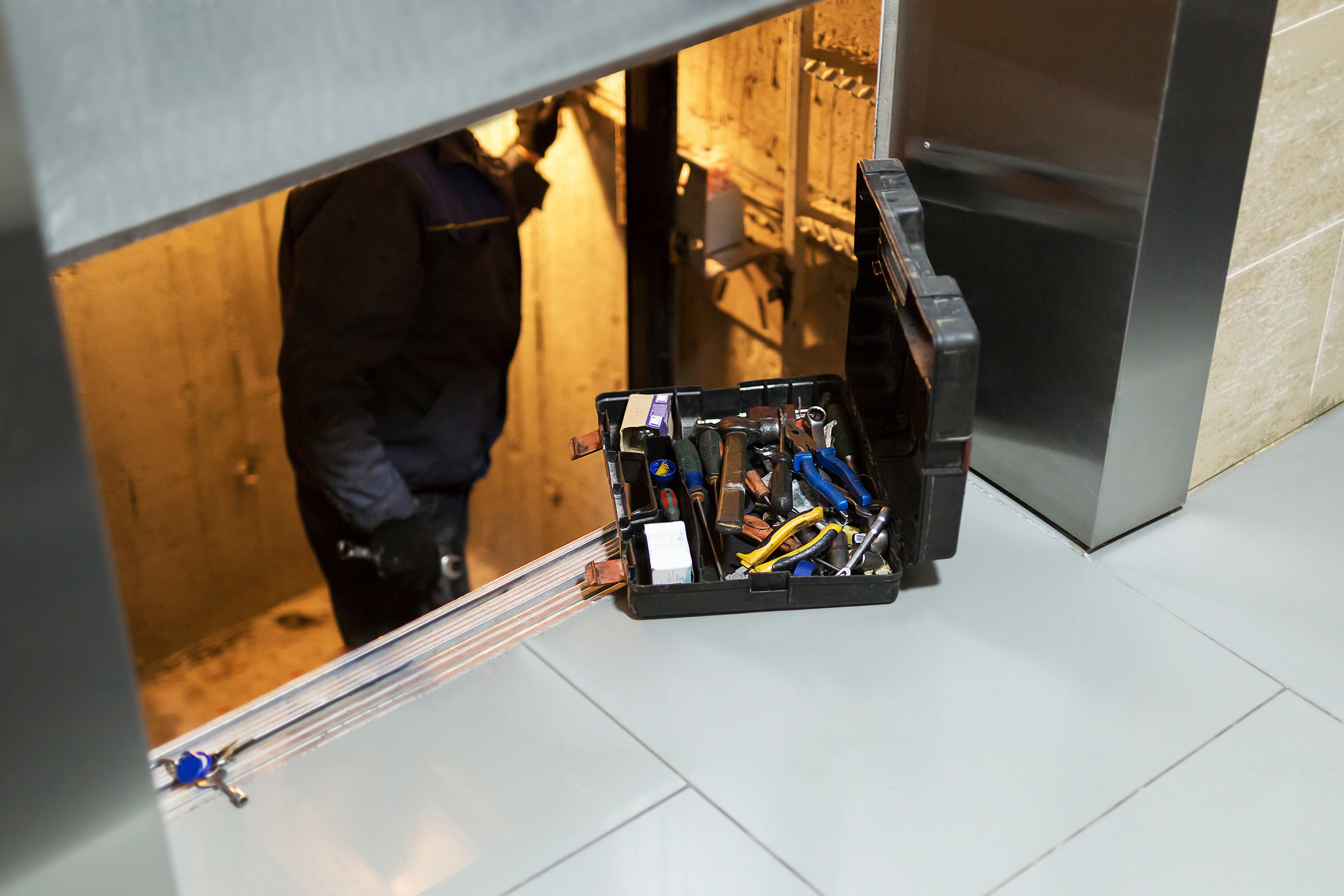 a person repairing an elevator