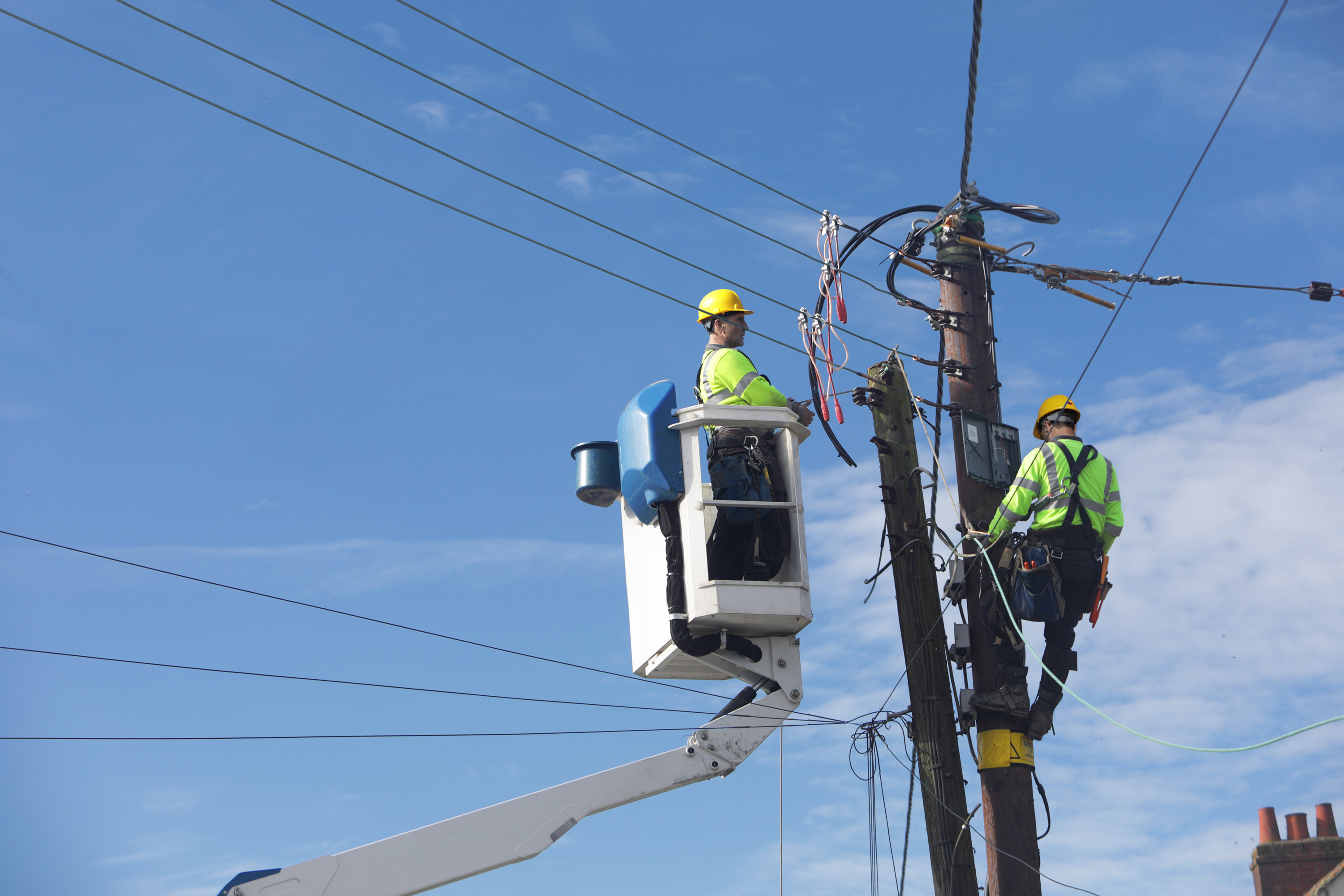 two power line technicians working