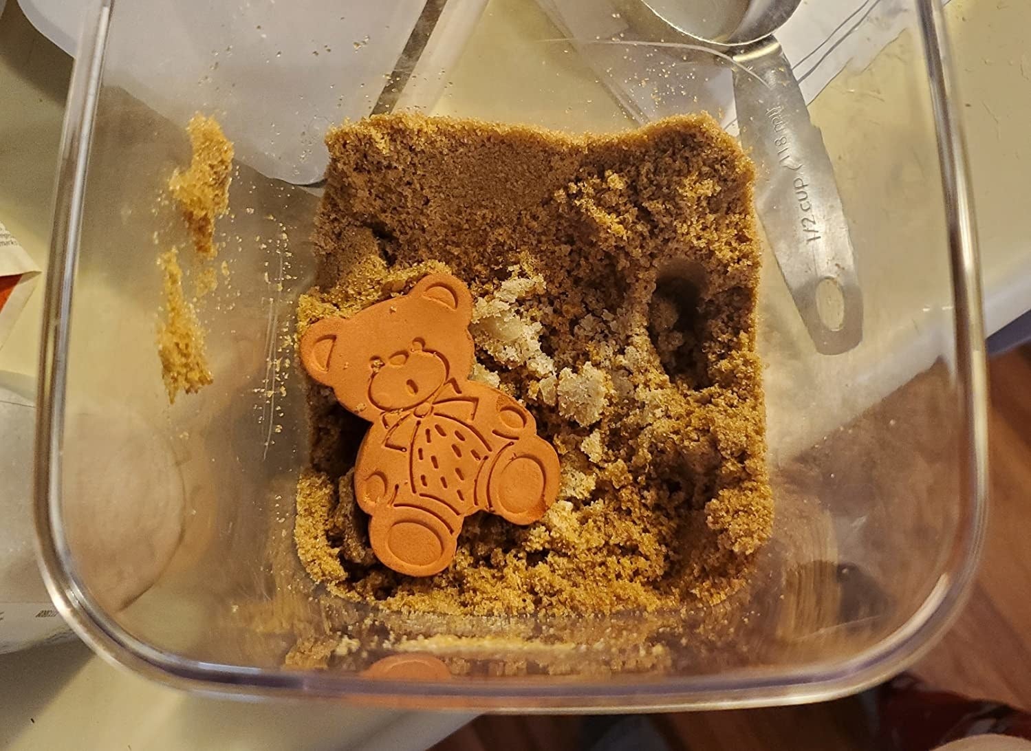 Reviewer image of bear-shaped softener in a container of brown sugar