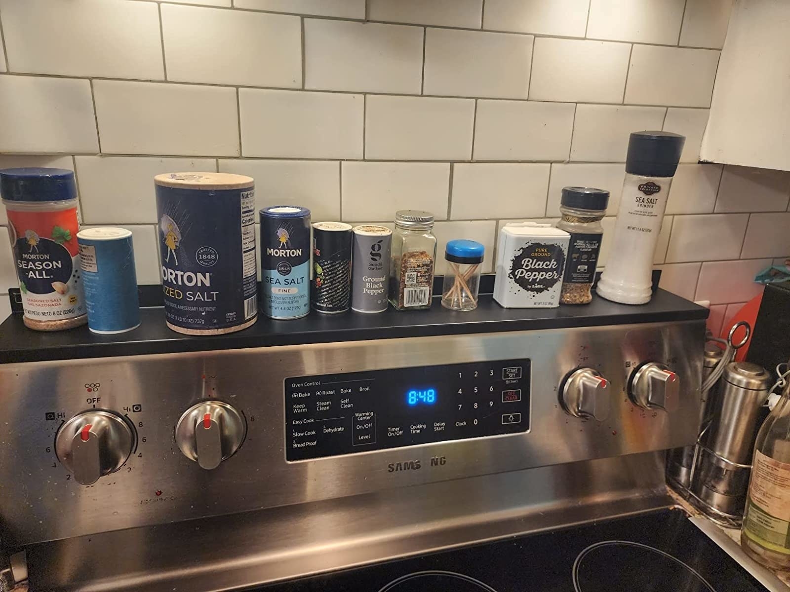 Reviewer image of the shelf on their stove holding seasonings