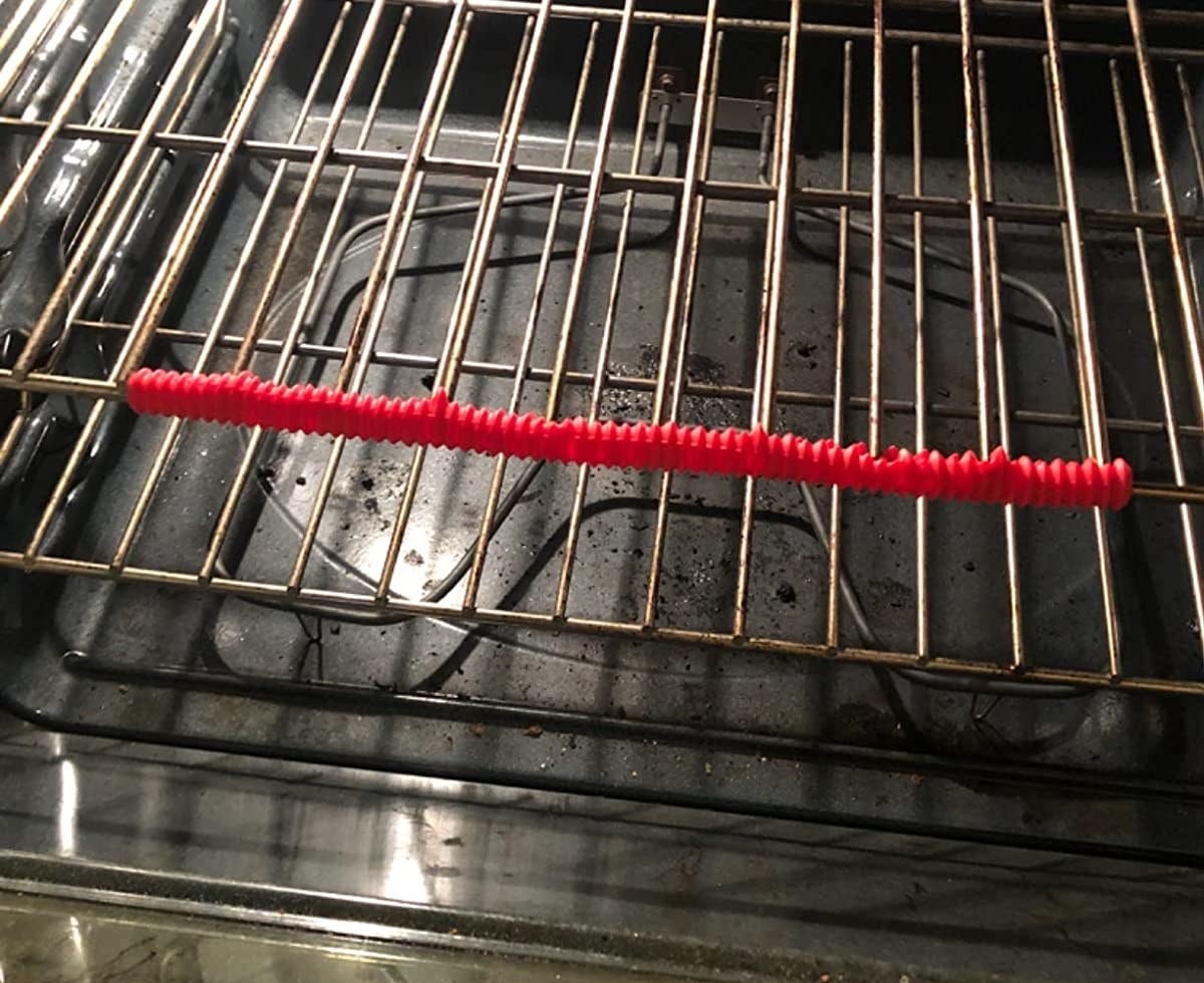 Reviewer image of red silicone guard on their oven rack