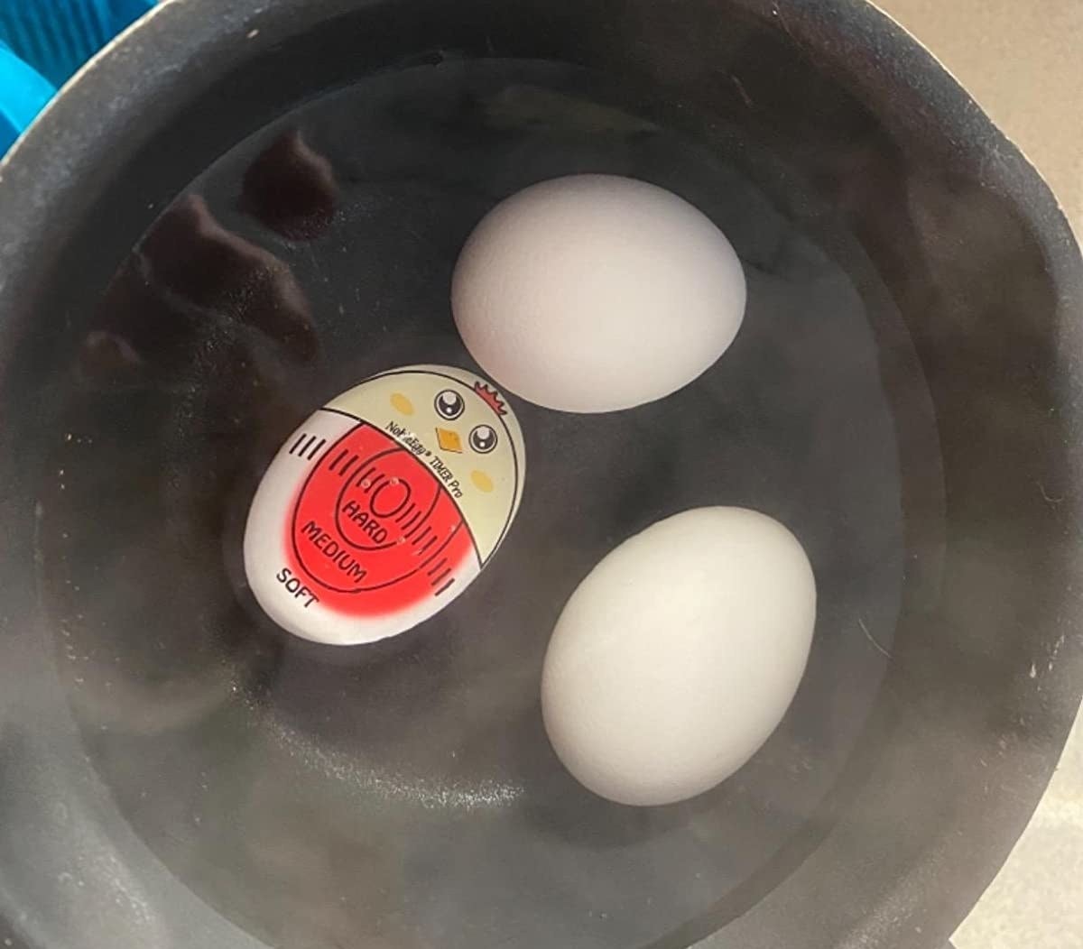 Reviewer image of egg timer in a pot with water and two eggs