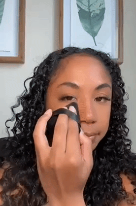 A gif of someone using the puff to apply powder