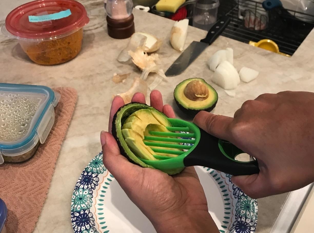 Reviewer cutting an avocado with the slicer