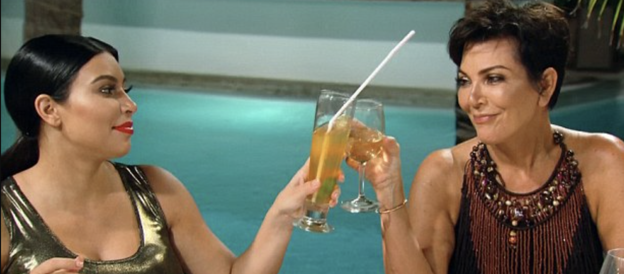 Kourtney Kardashian and Kris Jenner tapping glasses