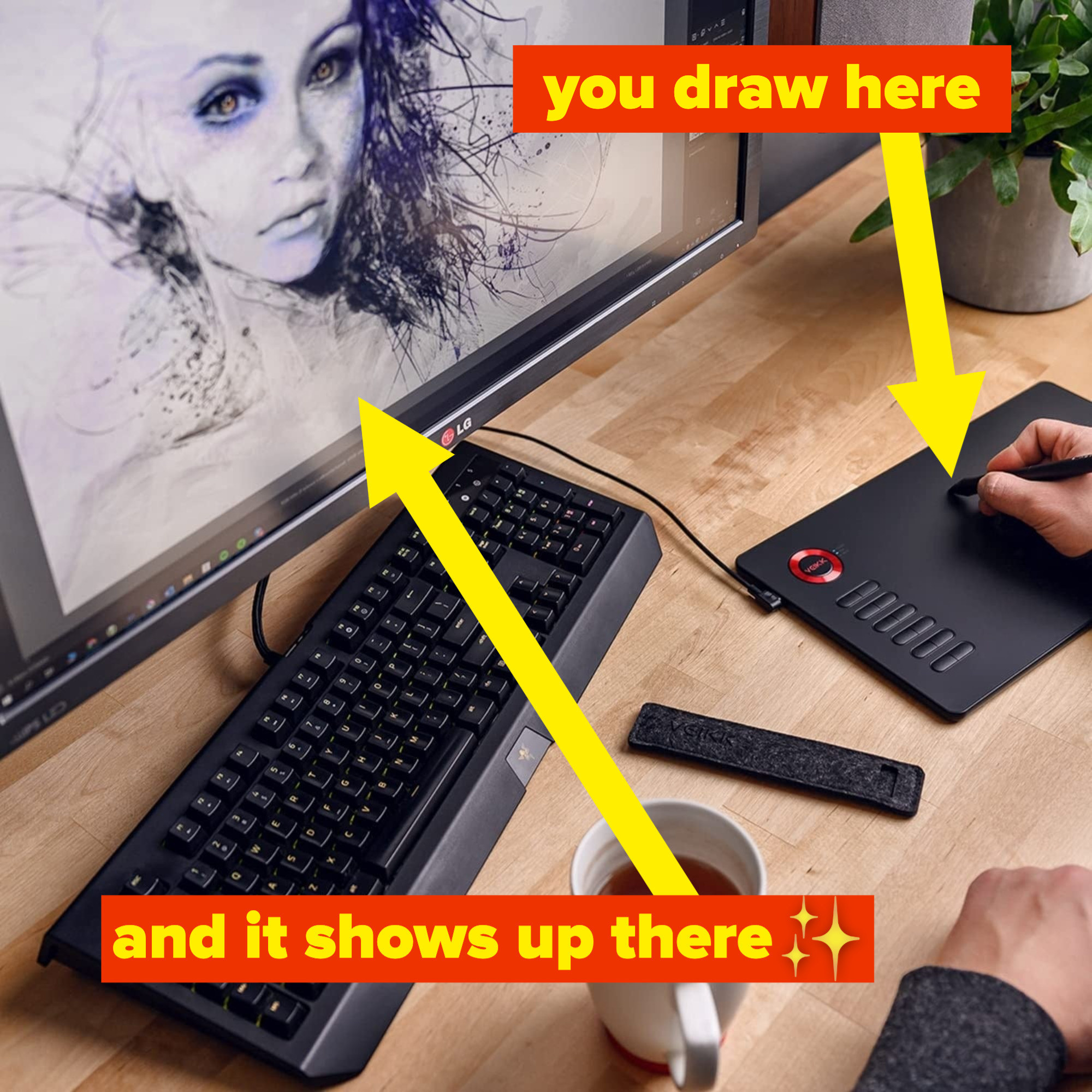 a person using a tablet to draw on a monitor