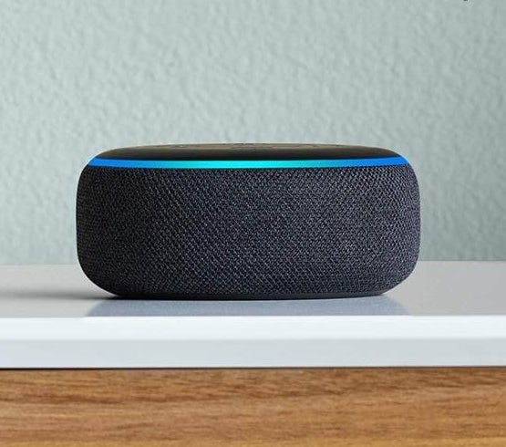an echo dot speaker on a wood surface