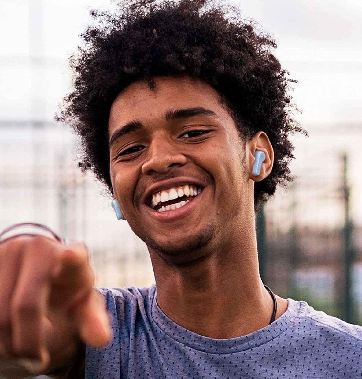 a person wearing a pair of jbl ear buds