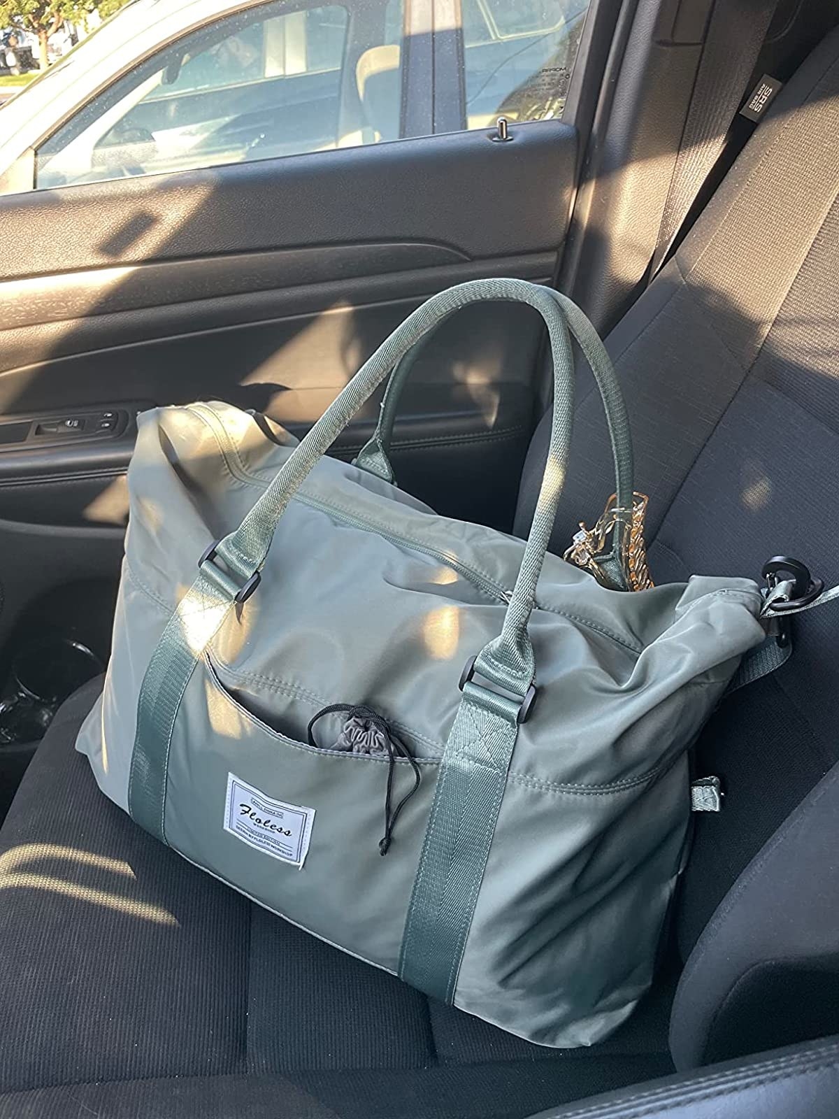 Reviewer image of green bag on their car seat