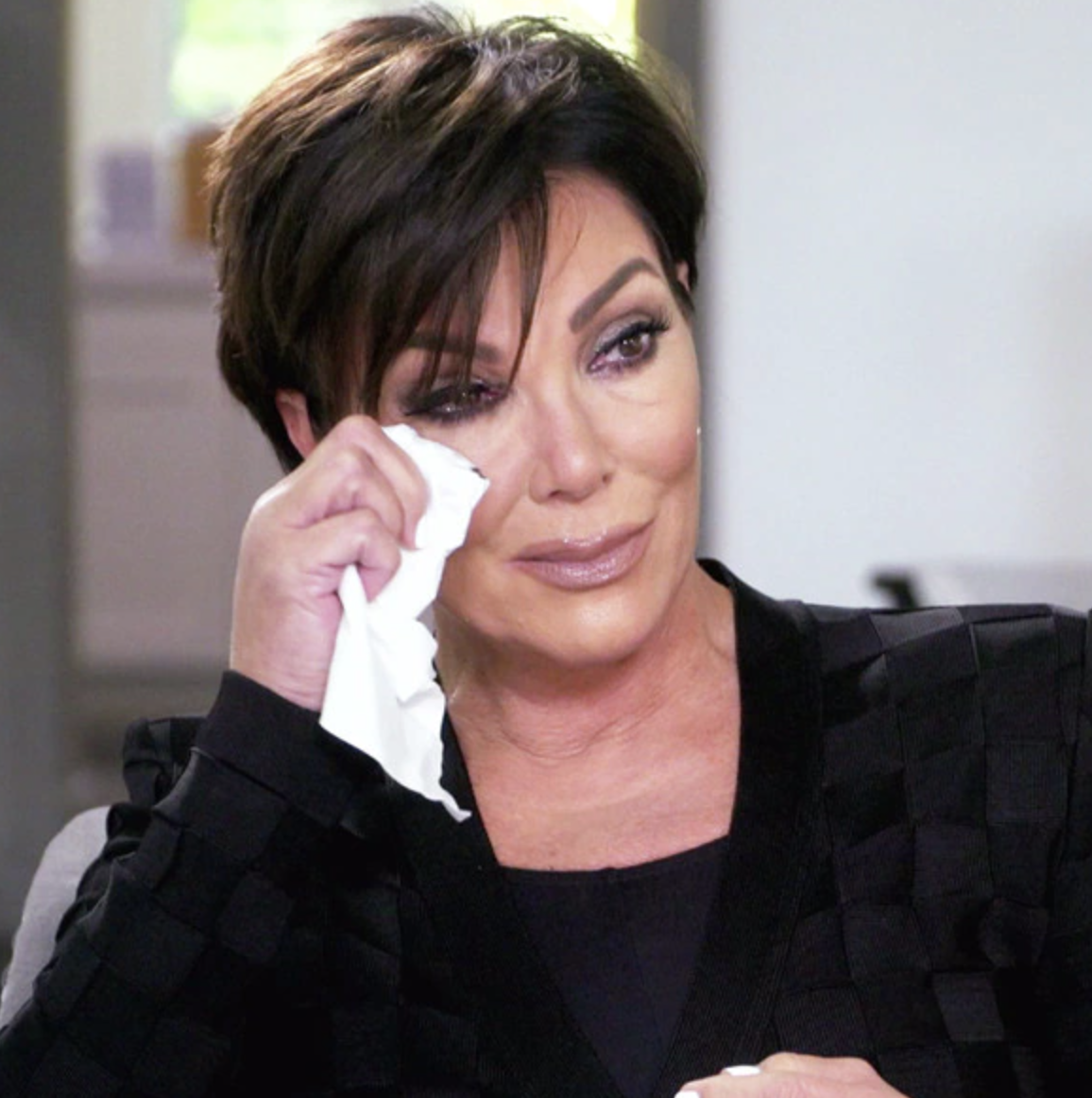 Kris Jenner wiping away a tear