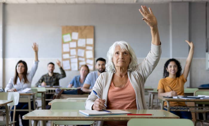 A class of people raising their hands