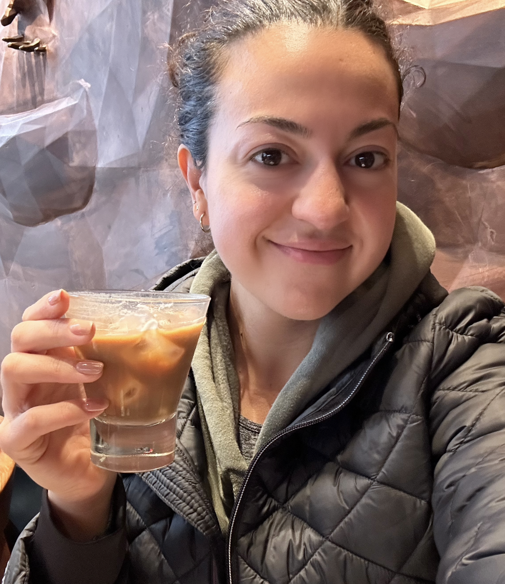 the author holding an iced coffee drink