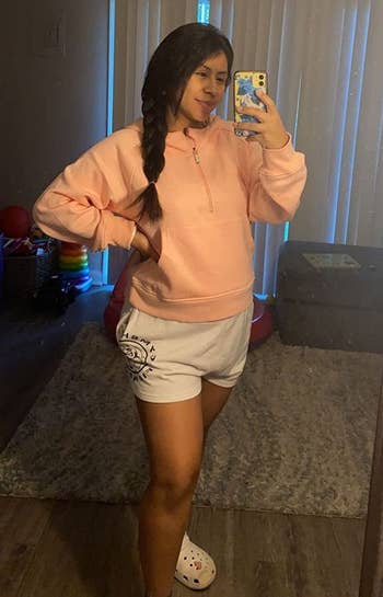 reviewer wearing the zip up in pink