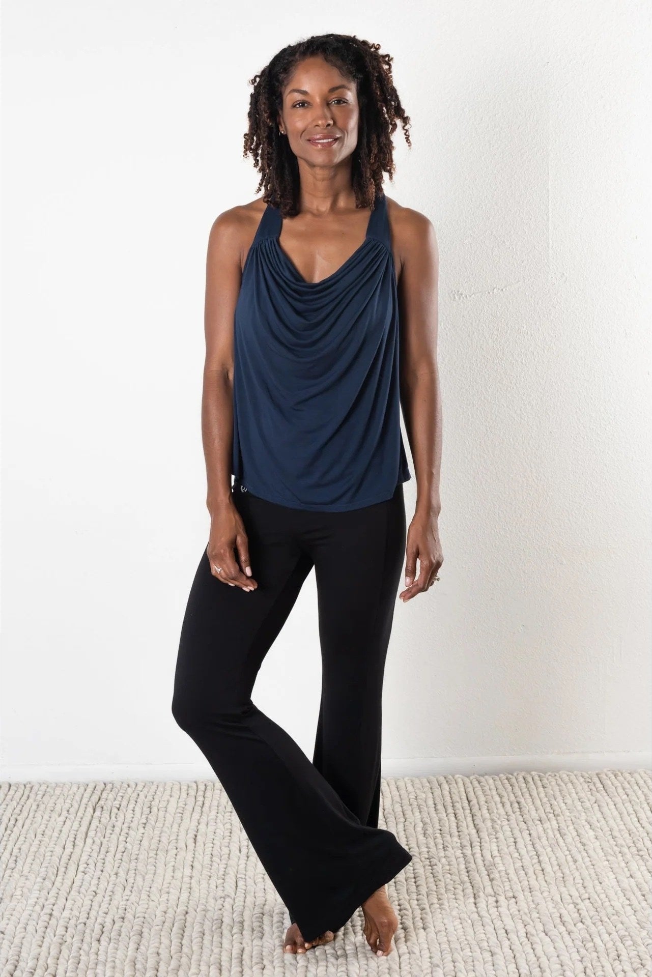 A model wearing black pants and blue top