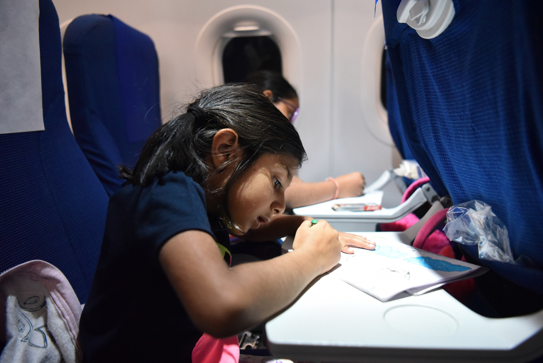 Kids coloring on a plane