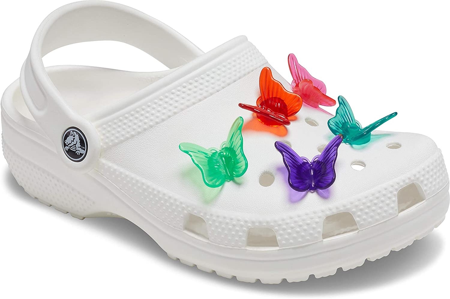 Green, red, pink, purple, and blue butterfly clip croc charms on a pair of white crocs
