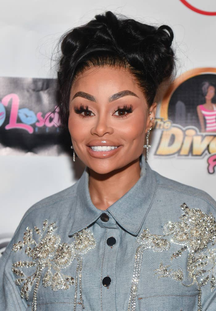 Close-up of Blac Chyna smiling at a red carpet event. Chyna is wearing a bejeweled denim top