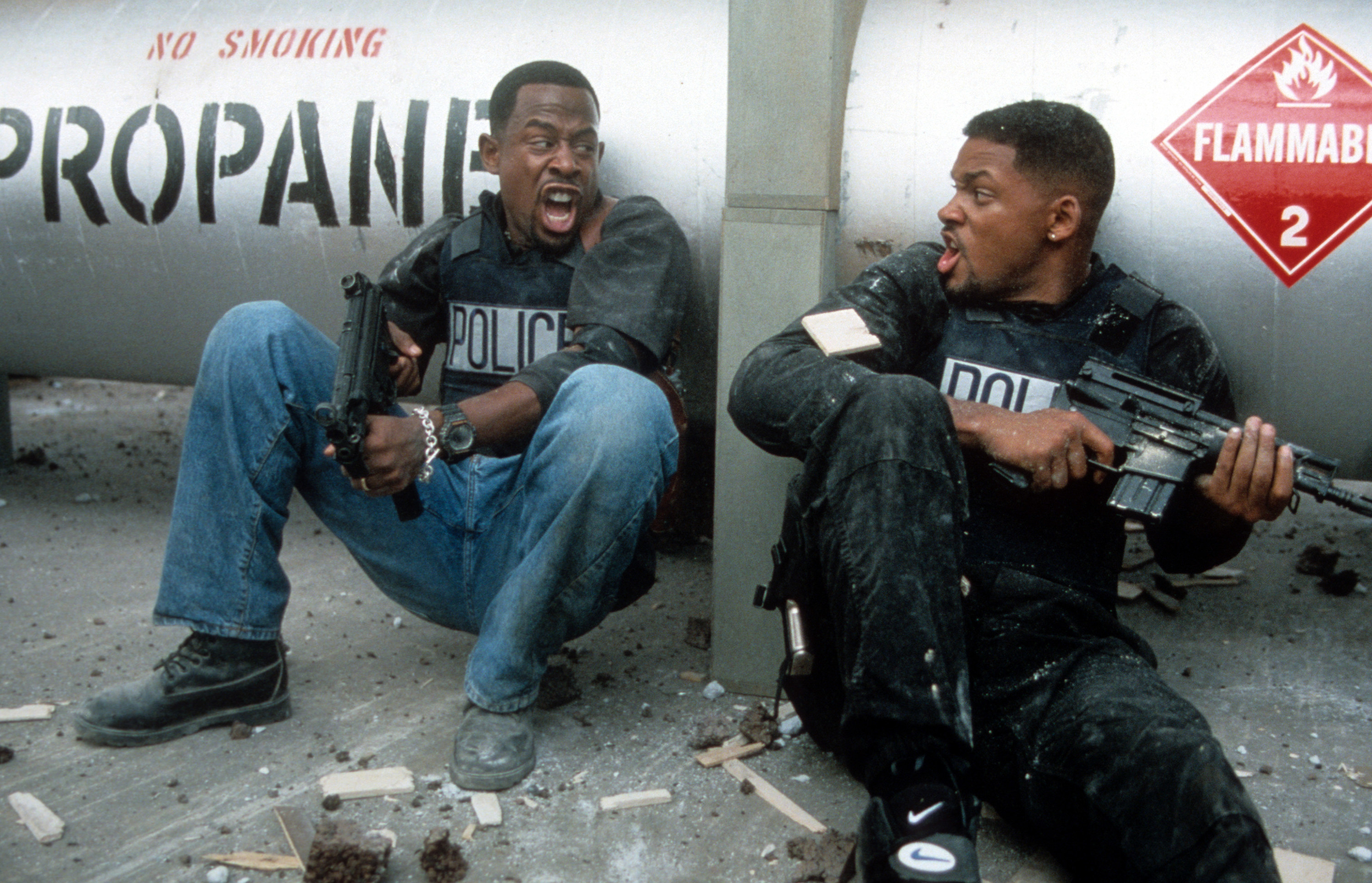 Martin Lawrence and Will Smith yelling at each other while holding machine guns to defend themselves in a scene from the film &#x27;Bad Boys&#x27;, 1995