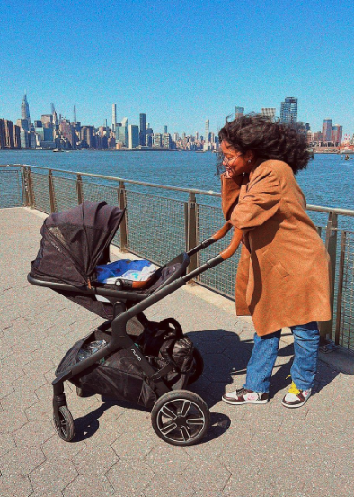 keke looking into the stroller of her baby