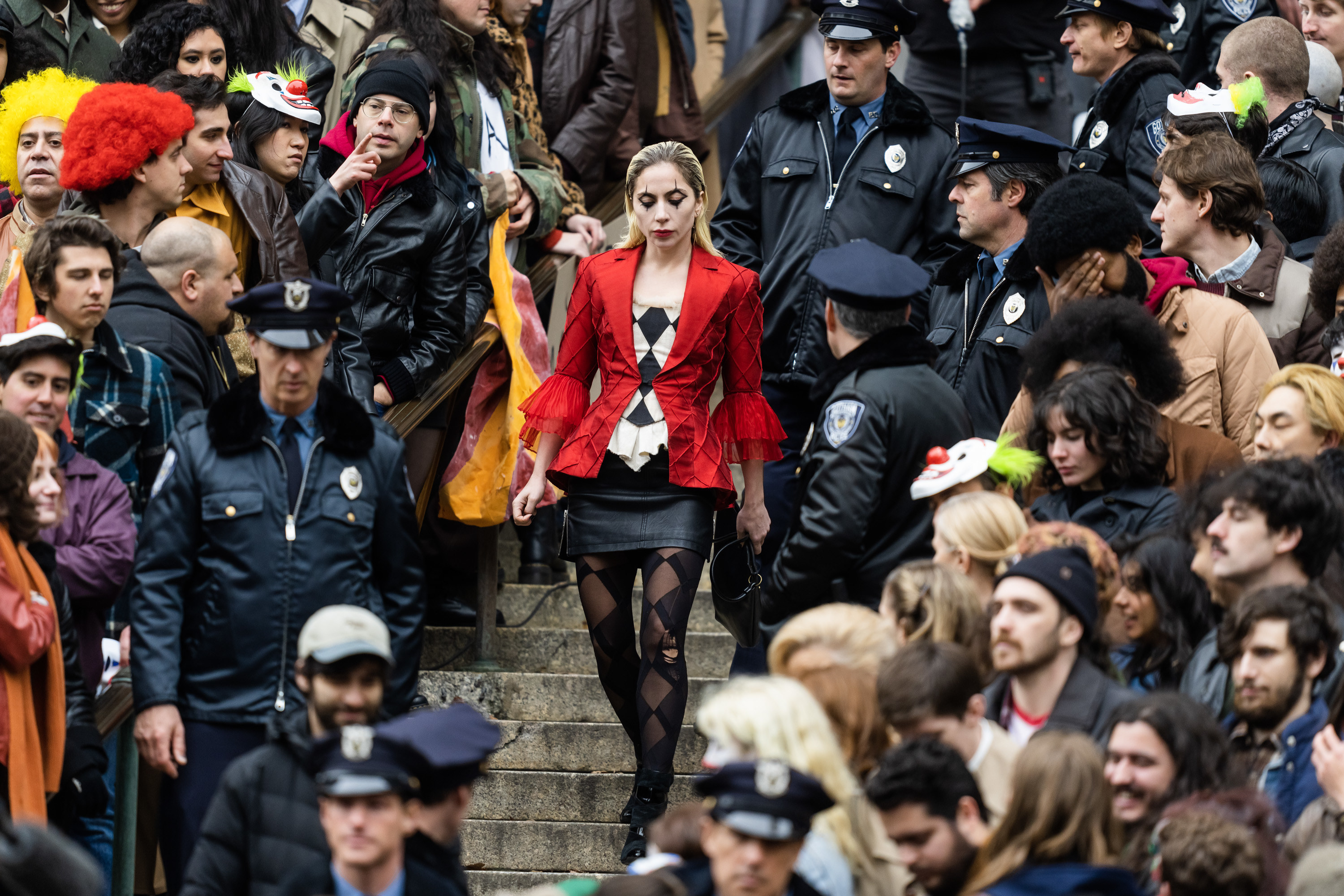 lady gaga in a crowd of people during filming