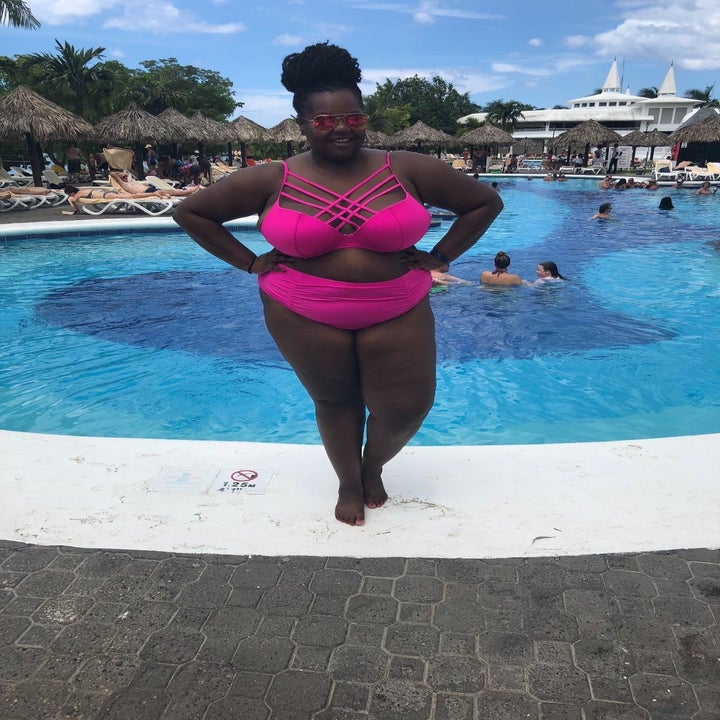 Reviewer wearing the hot pink swimsuit