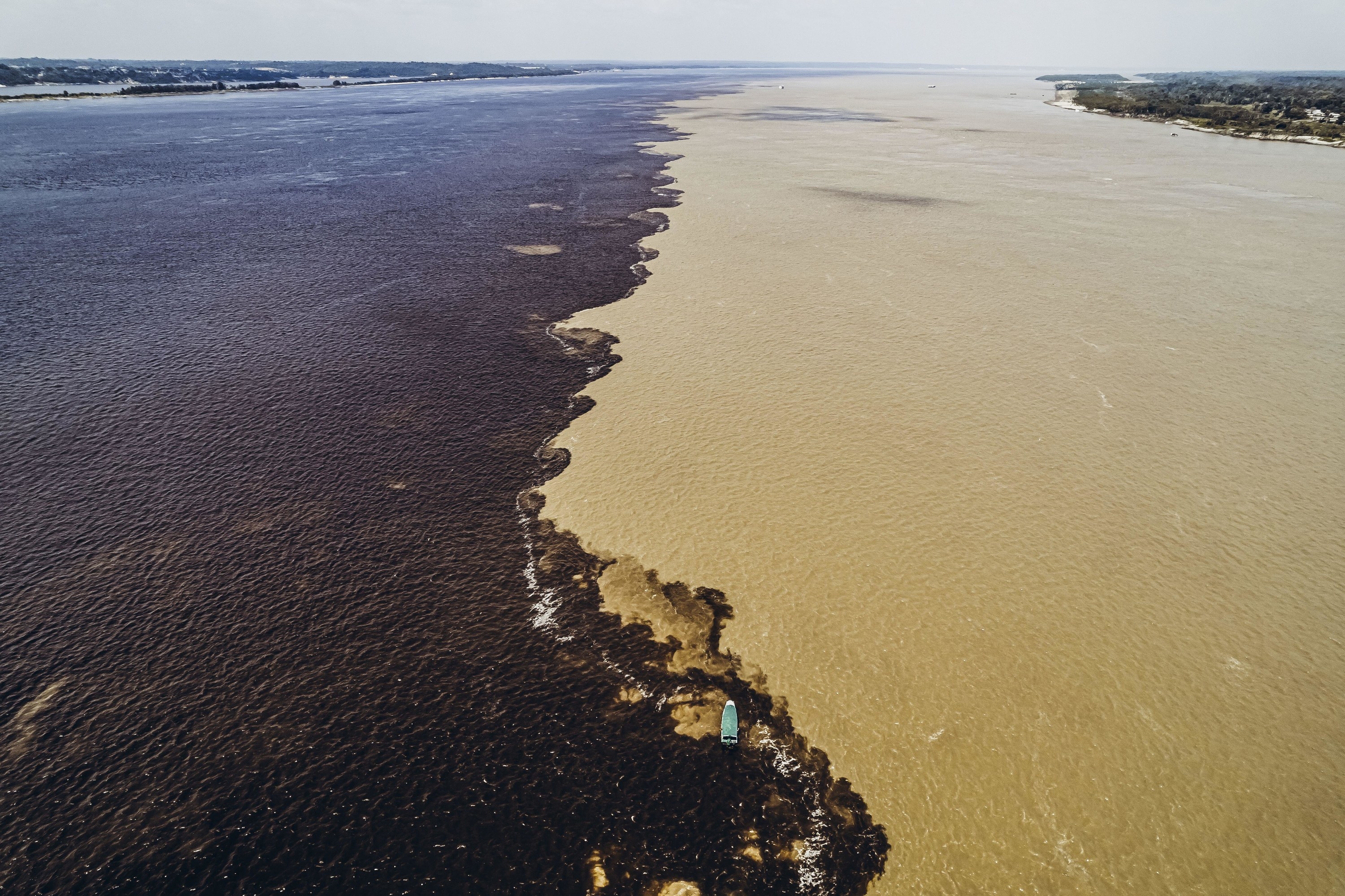 One river is dark, the other looks sand-colored