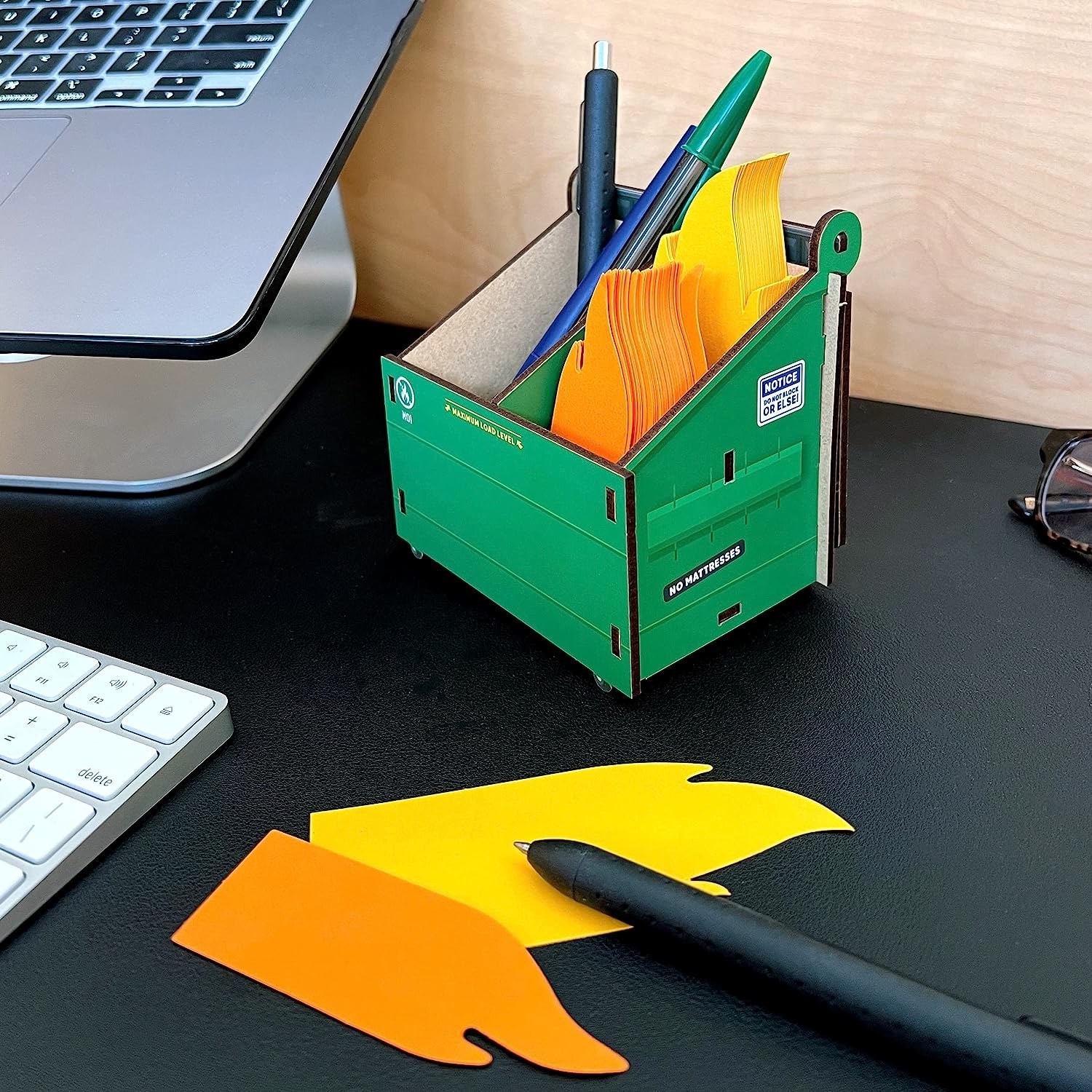 a dumpster shaped desk organizer filled with flame shaped note cards