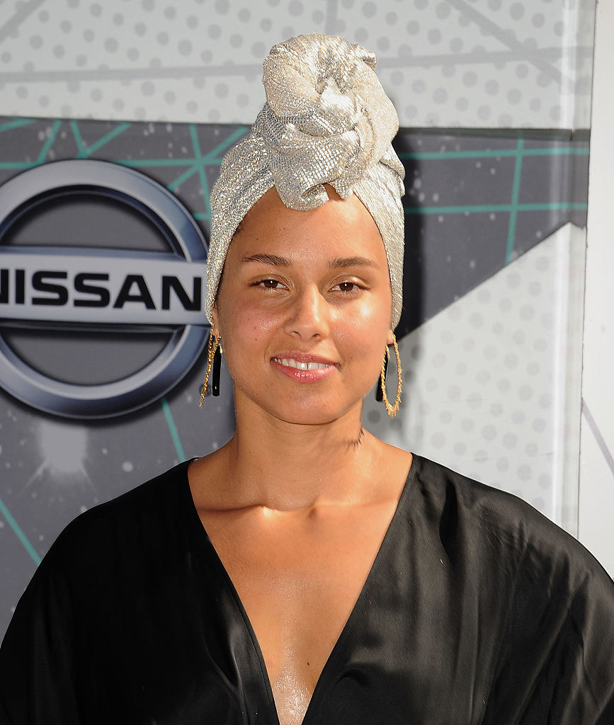 Close-up of Alicia with a silvery head wrap and no makeup