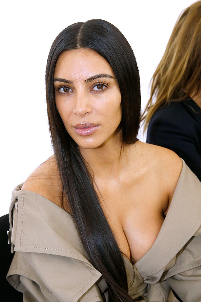 Close-up of no-makeup Kim in an off-the-shoulder, deep-V outfit