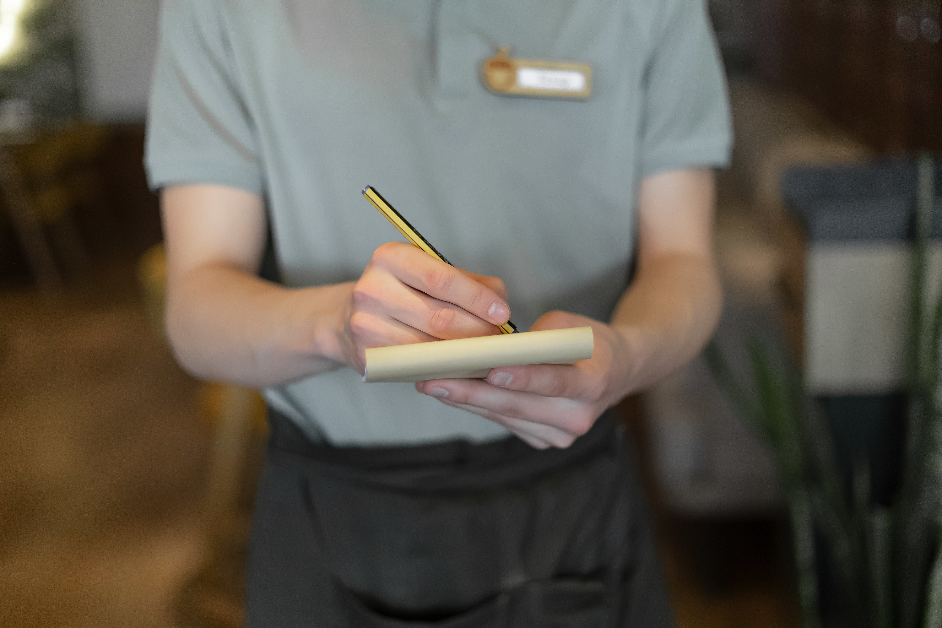 Close up of waiter with notebook taking order in a restaurant