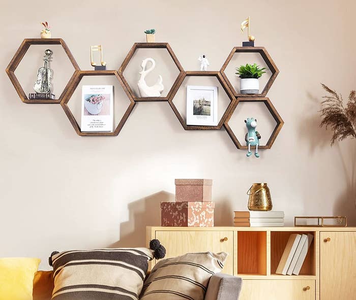 the honeycomb shelves on a wall behind a couch