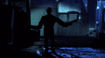 Freddy Krueger walks menacingly down a dark alleyway