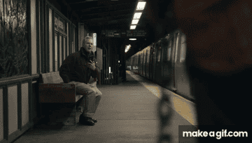 A older white man stands up near a man holding a chain on a subway platform in &quot;Poundcake&quot;