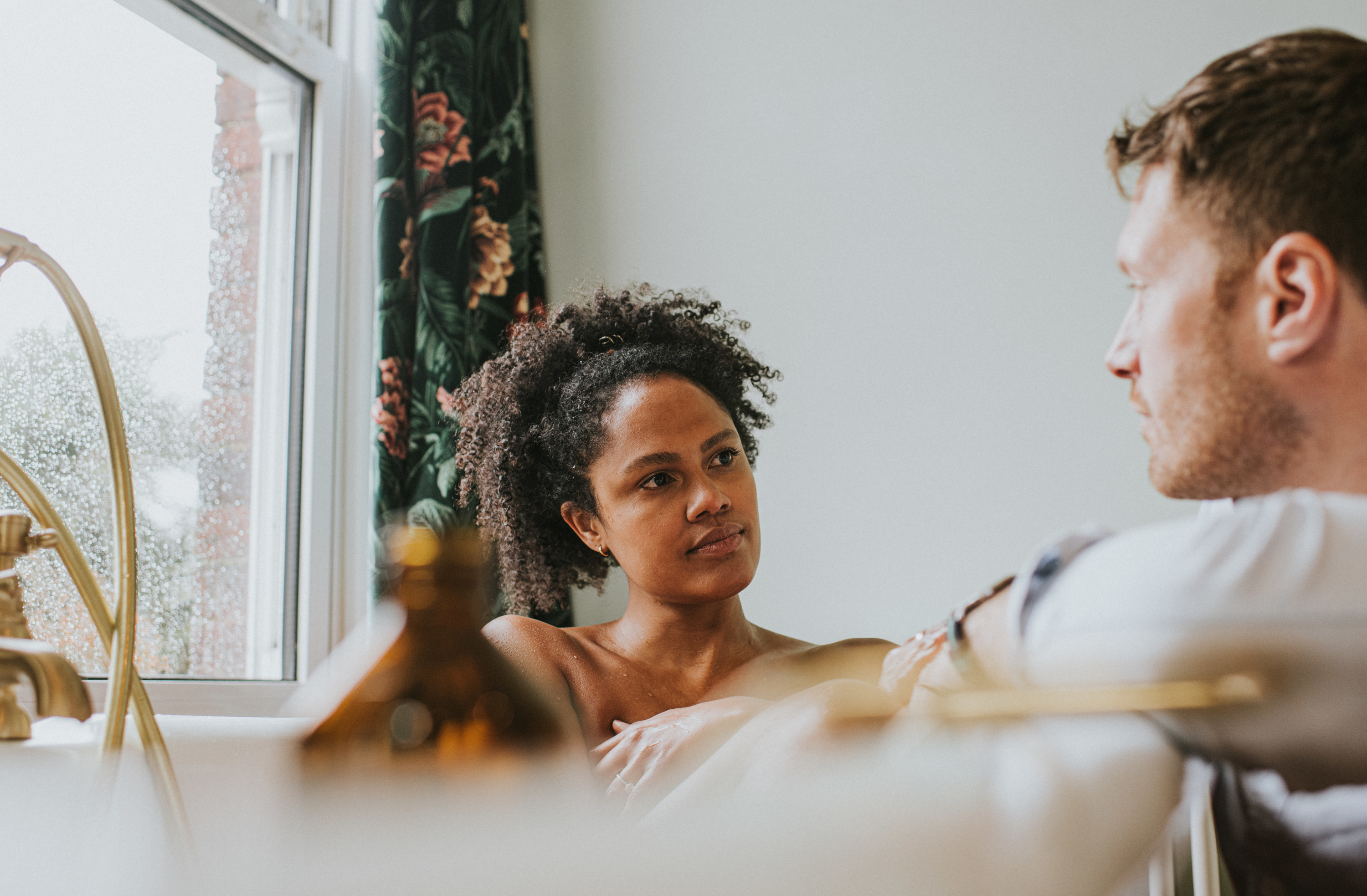 A couple talking in a bathroom