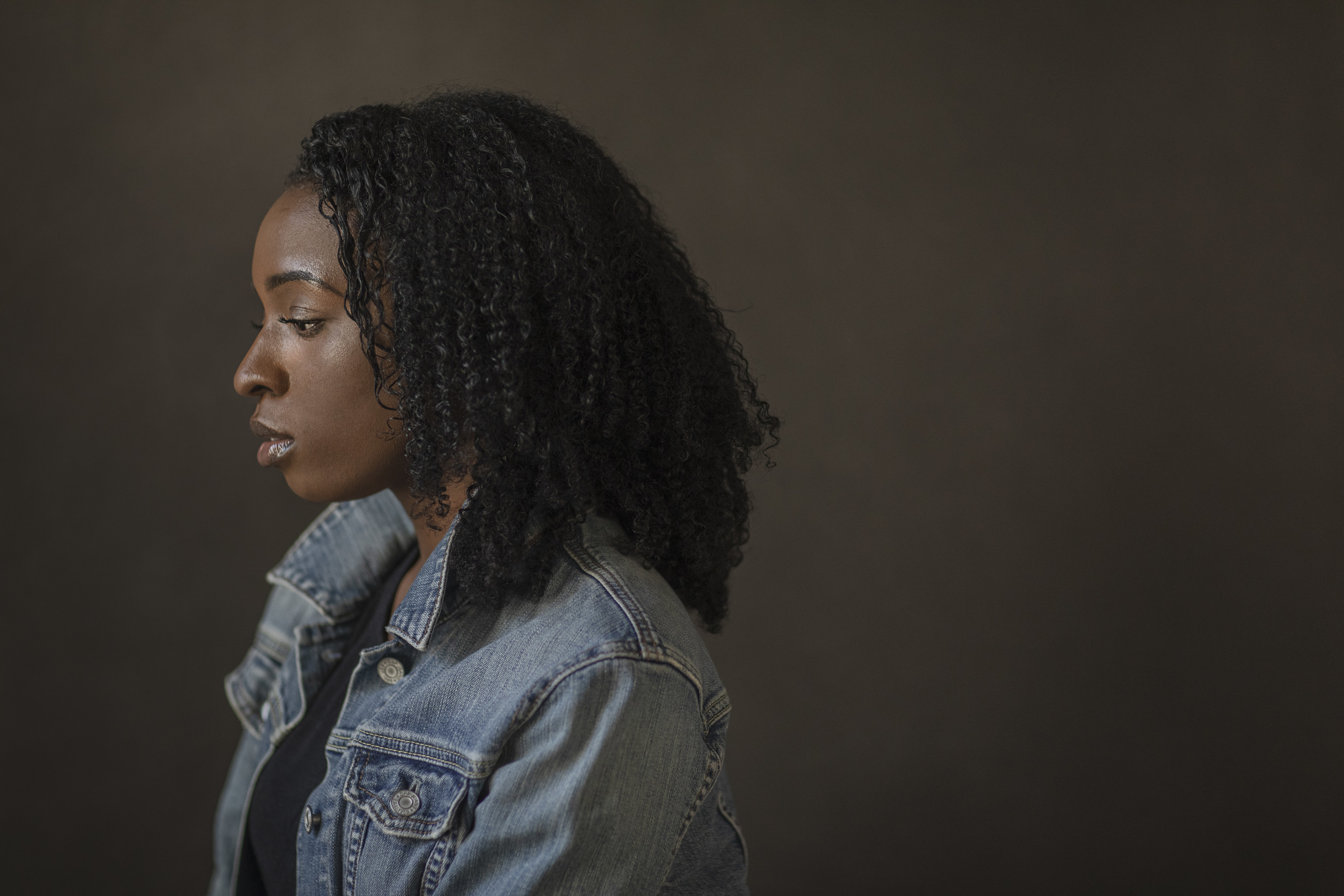 A woman looking down and serious