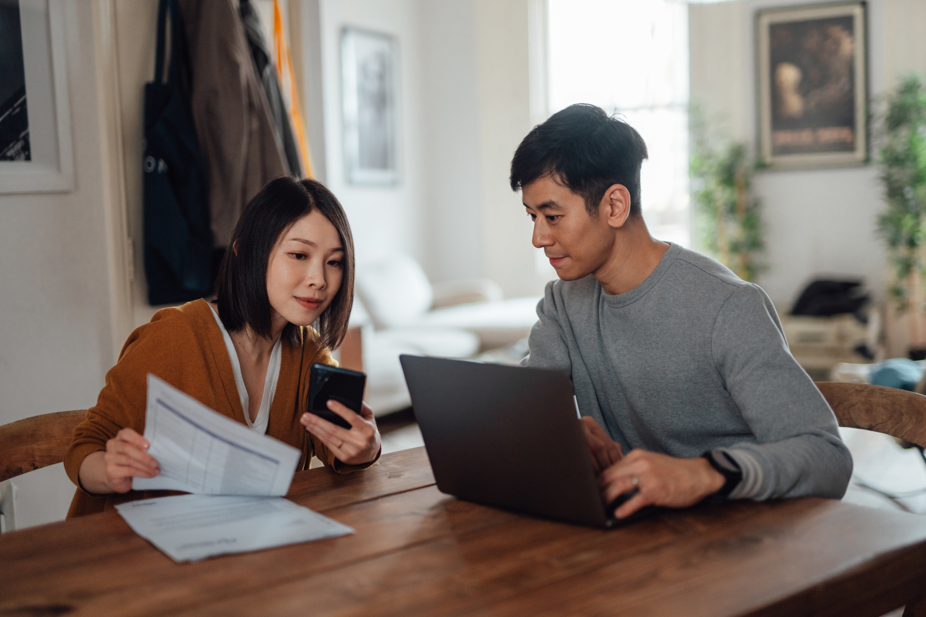 A couple doing bills together at a table