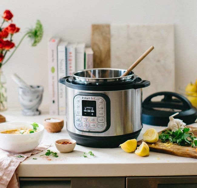 the instant pot surrounded by food on a counter