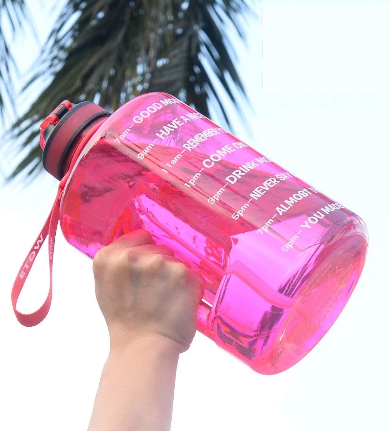 someone lifting the enormous time marked water bottle into the air