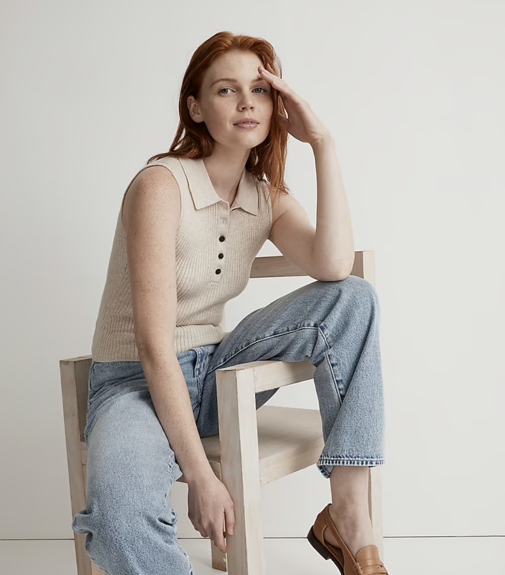 A person with red hair wearing the shirt in beige with a pair of jeans