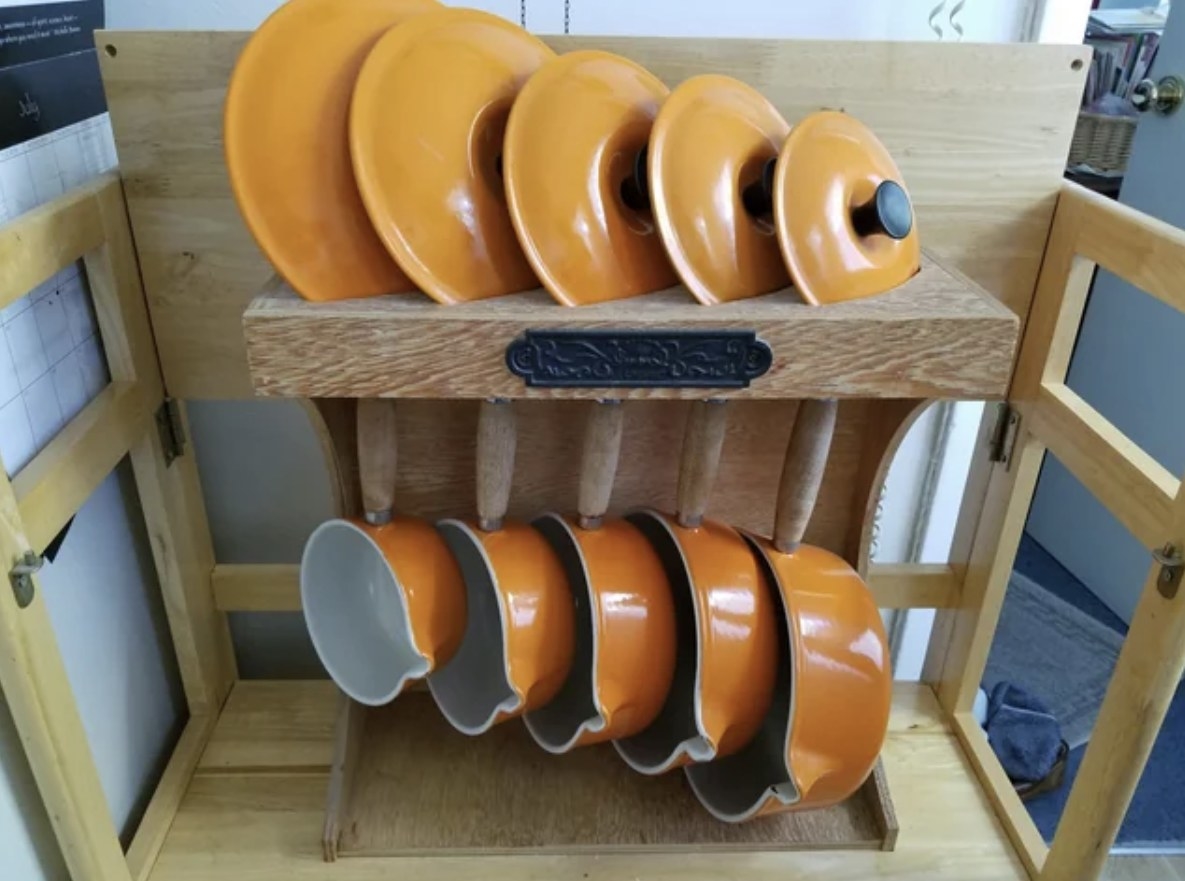 set of pots hanging on a rack