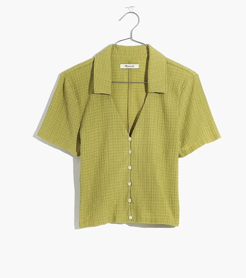 The top in a light olive green color