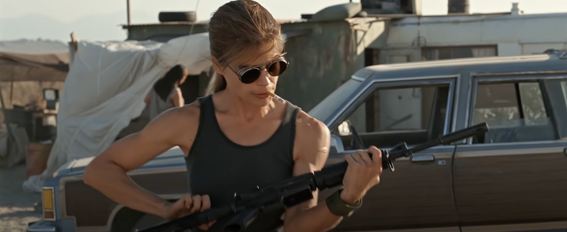 Sarah Connor loads a gun with sunglasses on