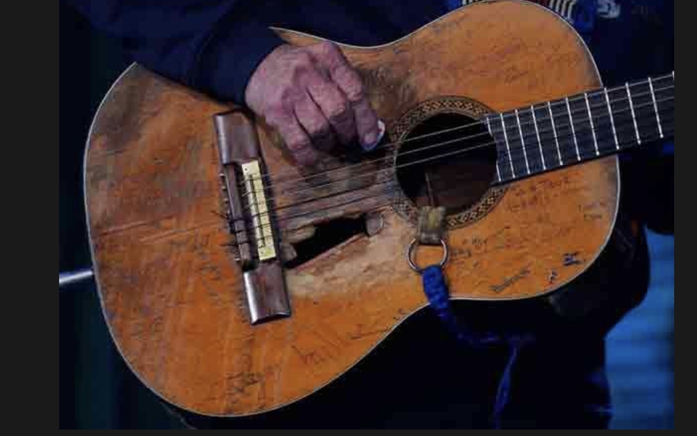 Willie Nelson playing his guitar Trigger