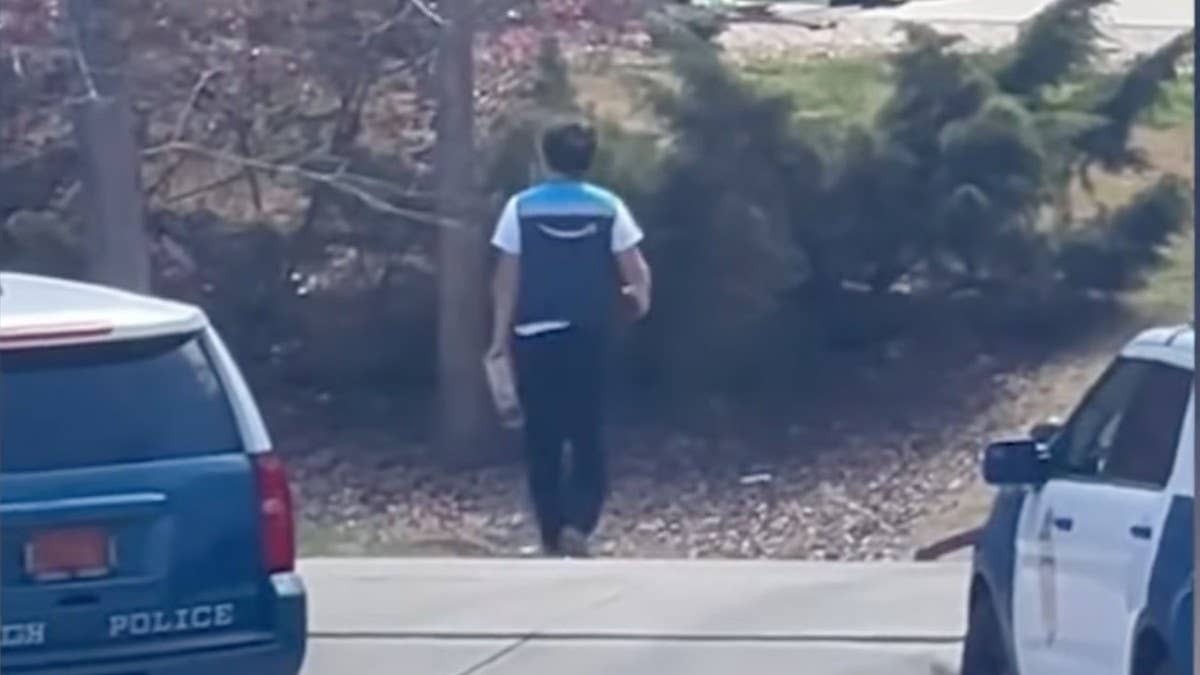 An Amazon driver has gone viral for his impeccable worth ethic after he delivered a package to someone's door during a tense police standoff in North Carolina.